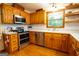 Well-lit kitchen featuring wooden cabinets, modern appliances, and white countertops at 1655 Stacia Dr, Covington, GA 30016