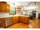 Spacious kitchen with wooden cabinets, stainless steel appliances, and hardwood floors at 1655 Stacia Dr, Covington, GA 30016