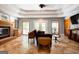 Living room featuring tile floors, cozy fireplace, and large windows for an airy atmosphere at 1655 Stacia Dr, Covington, GA 30016