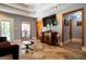 Living room with tile floors, a mounted TV, and large windows providing natural light at 1655 Stacia Dr, Covington, GA 30016