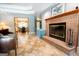 Inviting living room showcasing a brick fireplace, tile floors, and an open view to the adjacent dining area at 1655 Stacia Dr, Covington, GA 30016