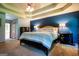 Spacious main bedroom featuring a tray ceiling, carpet floors, and accent wall at 1655 Stacia Dr, Covington, GA 30016