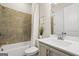 Bathroom featuring a shower-tub combo with tiled walls, a toilet, and a vanity with white countertop at 1058 Kirkland Cir, Smyrna, GA 30080