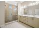 Bathroom showcasing a stone shower with a glass door and dual vanity sinks at 1058 Kirkland Cir, Smyrna, GA 30080