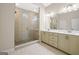 Bathroom featuring double vanity, and glass enclosed shower with tile surround at 1058 Kirkland Cir, Smyrna, GA 30080