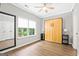Bedroom featuring wood-look floors, large windows, a closet, and a murphy bed at 1058 Kirkland Cir, Smyrna, GA 30080