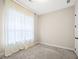 Bright bedroom with large window covered by sheer curtains and neutral carpet at 1058 Kirkland Cir, Smyrna, GA 30080