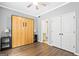 Bedroom showcasing a Murphy bed, neutral paint, ceiling fan, and closet access at 1058 Kirkland Cir, Smyrna, GA 30080