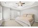 Bright bedroom with tray ceilings, ceiling fan, and neutral walls and carpet at 1058 Kirkland Cir, Smyrna, GA 30080