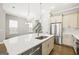 Bright kitchen with stainless steel appliances, a large island with seating, and modern pendant lighting at 1058 Kirkland Cir, Smyrna, GA 30080