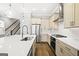Modern kitchen featuring an island with a sink, stainless steel appliances, and tile backsplash at 1058 Kirkland Cir, Smyrna, GA 30080