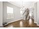 Open-concept living room with hardwood floors and large windows allowing ample light at 1058 Kirkland Cir, Smyrna, GA 30080
