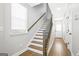 Bright entryway featuring a staircase with wooden handrail and hardwood floors at 1058 Kirkland Cir, Smyrna, GA 30080