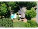 Overhead shot of a private backyard oasis including a pool, deck, and ample green space bordered by mature trees at 350 Ridgemont Dr, Fayetteville, GA 30215