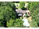 Aerial view of a landscaped backyard featuring a pool, a patio, a deck, and mature trees providing privacy at 350 Ridgemont Dr, Fayetteville, GA 30215