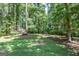Spacious backyard featuring lush greenery and mature trees, great for outdoor activities at 350 Ridgemont Dr, Fayetteville, GA 30215