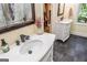 Bathroom featuring marble counters, stylish sinks, and decoratively framed mirror at 350 Ridgemont Dr, Fayetteville, GA 30215