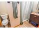 Cozy bathroom featuring a marble countertop vanity and shower with neutral-toned tile at 350 Ridgemont Dr, Fayetteville, GA 30215