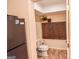 View of toilet and dark wood cabinets inside small but functional bathroom space at 350 Ridgemont Dr, Fayetteville, GA 30215