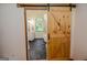 Charming bathroom showcasing dark tiled floor and sliding barn door at 350 Ridgemont Dr, Fayetteville, GA 30215