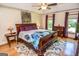 Sunlit bedroom features hardwood floors, a ceiling fan, and comfortable furnishings at 350 Ridgemont Dr, Fayetteville, GA 30215