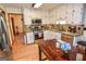 Well-lit kitchen featuring granite countertops, stainless steel appliances, and white cabinetry at 350 Ridgemont Dr, Fayetteville, GA 30215