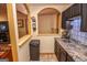 Bright kitchenette features dark cabinetry, granite countertop, and stainless steel sink at 350 Ridgemont Dr, Fayetteville, GA 30215