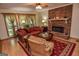 Living room featuring a brick fireplace, and a comfortable seating area with a ceiling fan at 350 Ridgemont Dr, Fayetteville, GA 30215
