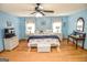 Bright main bedroom with beach decor, ceiling fan, and hardwood floors at 350 Ridgemont Dr, Fayetteville, GA 30215