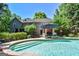 A stunning pool and backyard featuring a patio with lounge chairs and an umbrella for shade at 350 Ridgemont Dr, Fayetteville, GA 30215