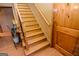 Classic wooden staircase with decorative iron spindles and a hardwood banister, complemented by natural light at 350 Ridgemont Dr, Fayetteville, GA 30215