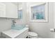 Bright bathroom features a modern vanity with a unique glass bowl sink and a window at 6072 Holiday Blvd, Forest Park, GA 30297