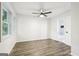Bright bedroom featuring wood-look floors, white trim windows, and ensuite bathroom at 6072 Holiday Blvd, Forest Park, GA 30297
