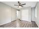 Bedroom showing wood-look flooring, closet, window, and open doorway to another room at 6072 Holiday Blvd, Forest Park, GA 30297