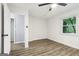 Bedroom showcasing wood-look flooring, a ceiling fan, and a side view of the backyard at 6072 Holiday Blvd, Forest Park, GA 30297