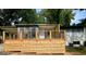 Charming home featuring a new wooden deck with black metal railings at 6072 Holiday Blvd, Forest Park, GA 30297