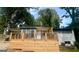 Charming home featuring a new wooden deck with black metal railings at 6072 Holiday Blvd, Forest Park, GA 30297
