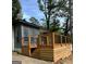 Charming home featuring a new wooden deck with black metal railings at 6072 Holiday Blvd, Forest Park, GA 30297