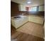 Compact basement kitchen featuring white cabinets, gas cooktop, and tiled floor at 6072 Holiday Blvd, Forest Park, GA 30297