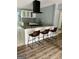 Stylish kitchen island featuring modern stools, granite countertops, and sleek appliances at 6072 Holiday Blvd, Forest Park, GA 30297