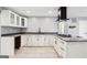 Updated kitchen featuring white cabinets, granite countertops, and a gas cooktop with sleek fixtures at 6072 Holiday Blvd, Forest Park, GA 30297