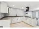 Modern kitchen with white cabinets, granite countertops, and a gas cooktop on the island at 6072 Holiday Blvd, Forest Park, GA 30297