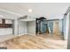 Spacious living room featuring unique spiral staircase, wood-look floors and lots of natural light at 6072 Holiday Blvd, Forest Park, GA 30297