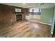 Open-concept living room with a brick fireplace and adjacent kitchen area at 6072 Holiday Blvd, Forest Park, GA 30297