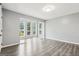 Bright, open living room featuring sleek wood-look floors and a large picture window at 6072 Holiday Blvd, Forest Park, GA 30297