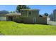 Backyard view of the home, showing the exterior with lush green lawn at 6120 Raleigh Oaks Ct, Lithonia, GA 30058