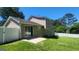Backyard view of home with sliding glass doors to a patio and fenced yard at 6120 Raleigh Oaks Ct, Lithonia, GA 30058