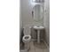 Cozy half bathroom with a pedestal sink, round mirror, and a toilet with a white seat at 6120 Raleigh Oaks Ct, Lithonia, GA 30058