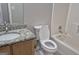 Bathroom featuring a vanity sink, a toilet with an open lid, and a bathtub with a shower at 6120 Raleigh Oaks Ct, Lithonia, GA 30058