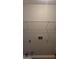 View of a basic closet with a wire shelf and visible utility connections, ready for organization at 6120 Raleigh Oaks Ct, Lithonia, GA 30058